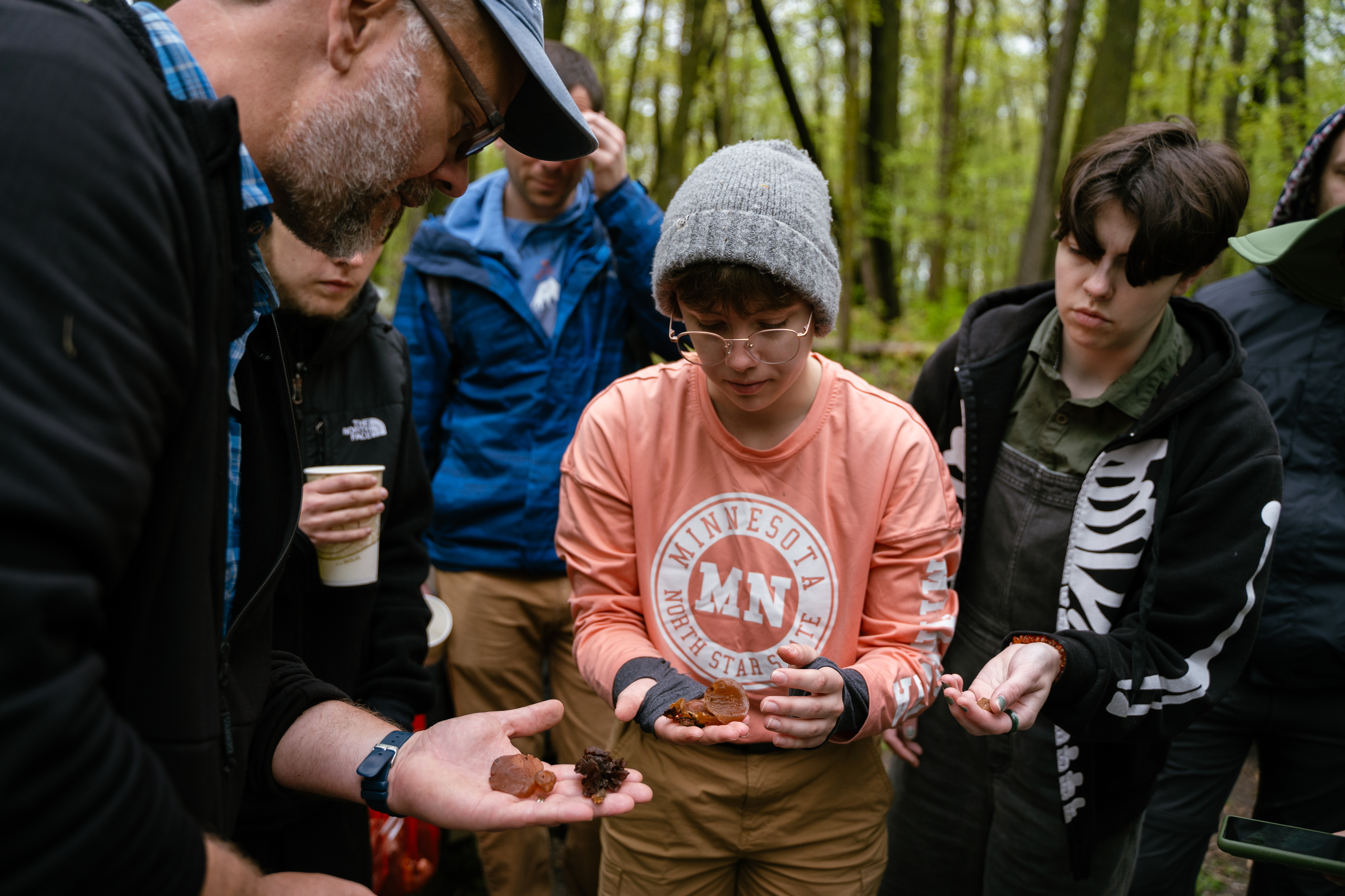 Students and instructor investigating a mushroom