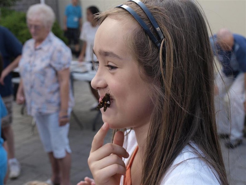 A visitor lands on Lauren after a butterfly release at Wonderlab's "Adventures in Animal Behavior"