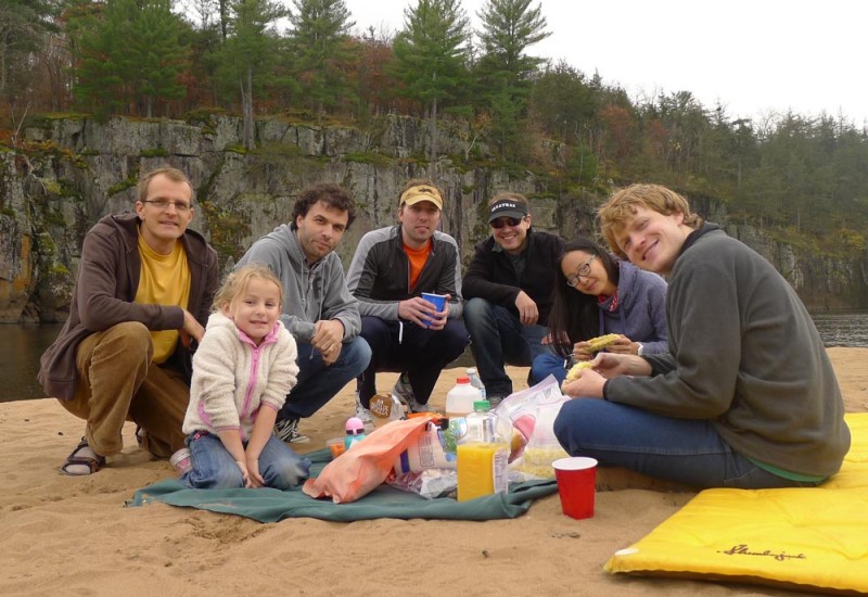 Members of the Seelig lab sitting on a beach with food