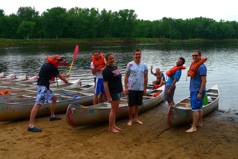 Seelig lab members on beach with canoes near river