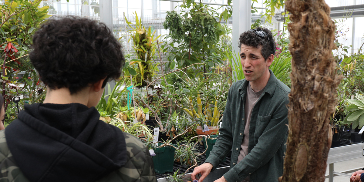 Jared Rubinstein showing students plants in the CBS Conservatory