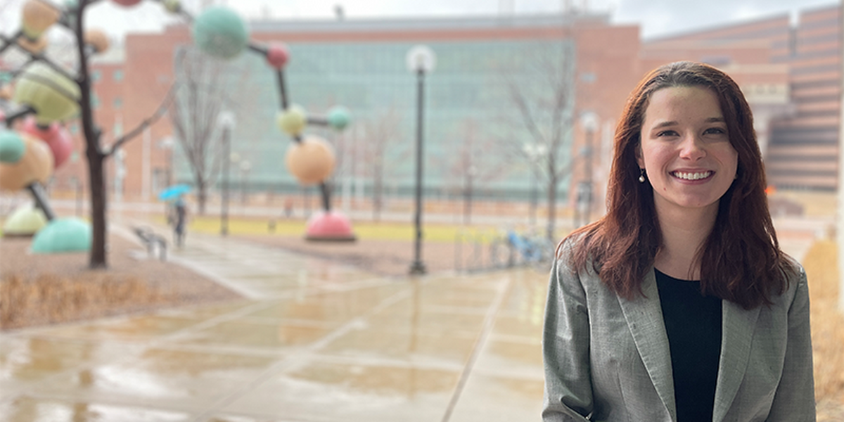 Madelyn Blake outside on campus wearing a grey blazer.