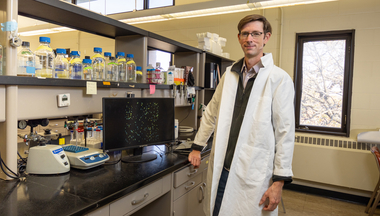 Will Harcombe standing in the lab