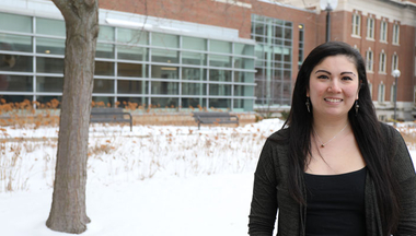 Callie Gustafson stands outside MCB building wearing a black shirt