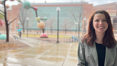 Madelyn Blake outside on campus wearing a grey blazer.