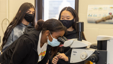 Students using microscope in lab