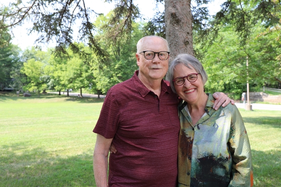 Linda Maschwitz in a green shirt and David Maschwitz in a red shirt smile for the camera.